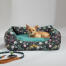 Chihuahua sdraiato in un letto a nido Omlet nel disegno del prato di mezzanotte