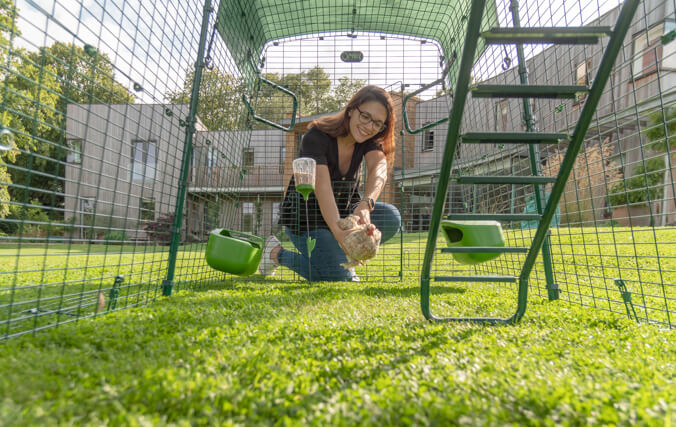 woman leaning into the eglu cube run